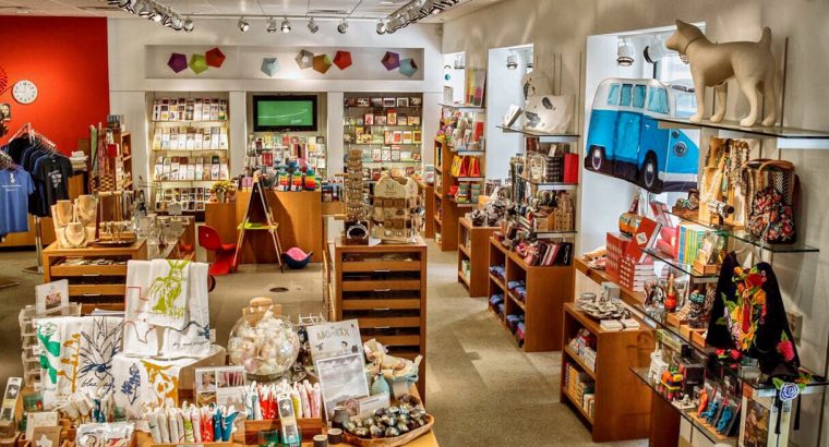 blanton museum shop interior - shelves, tables and windows full of colorful merchandise