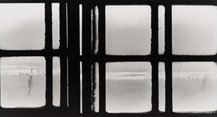 Image of a photograph by Fernando la Rosa featuring small groups of people gathered on a beach walking, laying down and playing in the water. Over top of the beach scene are horizontal and vertical black lines forming squares and thinner line shapes.