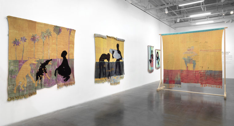 A view of four pieces by Diedrick Brackens, made out of woven cotton and acrylic yarn and silk organza,