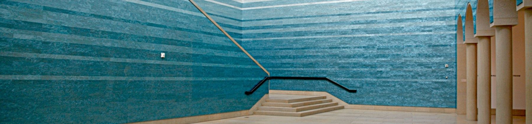 Wide shot of Blanton atrium installation "Stacked Waters" by Teresita Fernández, a vast immersive blue tile across various heights of the interior wall.