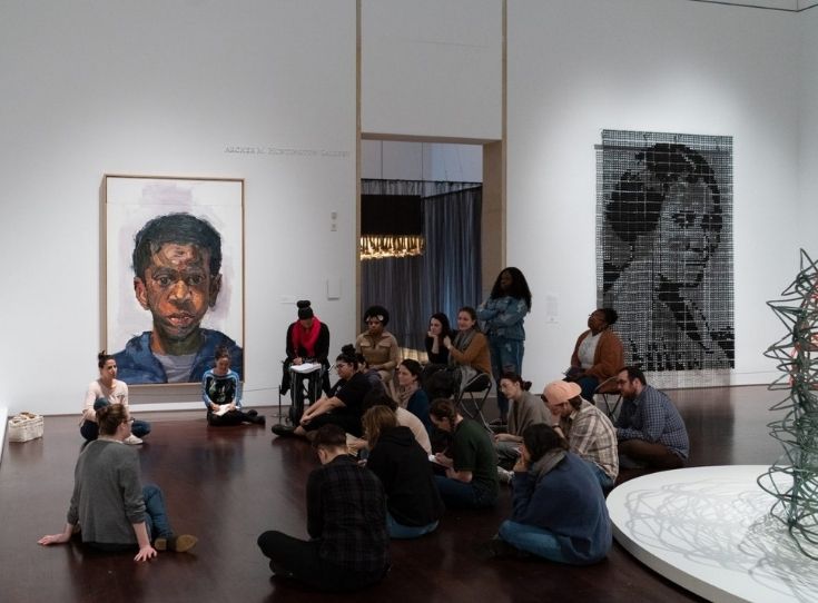 An Education group seated in a semi circle on the floor in the Blanton's Modern/Contemporary gallery